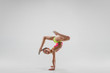 © master1305 - The teen female little girl doing gymnastics exercises isolated on a gray studio background. The gymnastic, stretch, fitness, lifestyle, training, sport concept