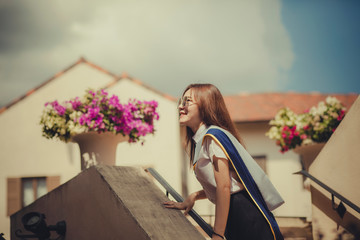 cheerful asian younger woman wearing university uniform pose street fashion style