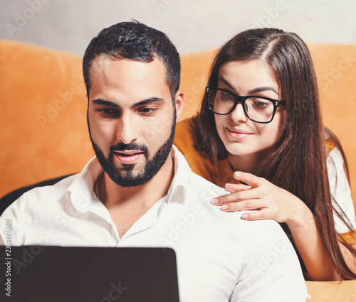 Pretty Long Haired Girl In Pullover Wearing Glasses Laying On The