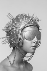 Futuristic woman in metal helmet and glasses