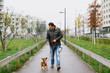 © TeamDF - A man and his little dog are practicing 'walking to heel' in the park