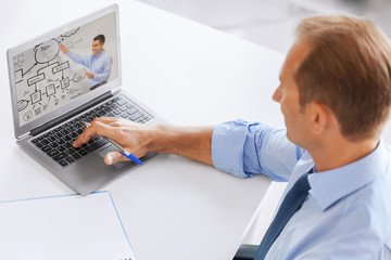 Poster - business, education and technology concept - businessman watching webinar on laptop computer at office