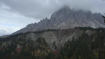 Wall Mural - Colorful scenic view of majestic Dolomites mountains in Italian Alps. Majestic rocky mountains surrounded with yellow trees in autumn time.