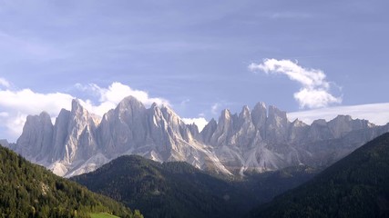 Wall Mural - Clouds passing over rocky peaks in Italian Dolomites near Santa Maddalena village in Val di Funes Valley, Italy.