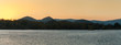 Lakeshore with mountain range at dawn