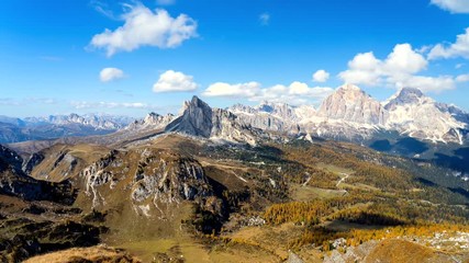 Wall Mural - Colorful scenic time-lapse of majestic Dolomites mountains in Italian Alps. Landscape shot of colorful trees and rocky mountains in the the Italian Dolomites during autumn time.