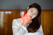 © 220 Selfmade studio - young Asian woman sitting on bed have a shoulder pain after wake up in the morning,Healthcare Concept