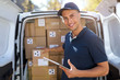 © pikselstock - Delivery man standing in front of his van