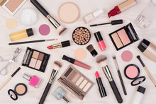 Makeup Cosmetics Such As Eyeshadows, Lipstick, Mascara And Makeup Accessories On White, Wooden Background, Top View