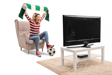 Wall Mural - Female soccer fan cheering with a scarf and watching a game