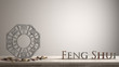 Wooden vintage table shelf with ba gua and 3d letters making the word feng shui with white blank background with copy space, zen concept interior design
