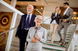© BGStock72 - Businessmen and businesswomen walking and taking stairs in an office building