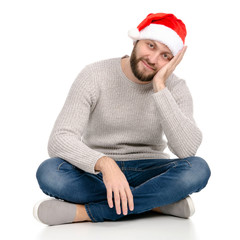 Wall Mural - A man in jeans sweater with Santa hat showing of positive emotions happy on a white background isolation