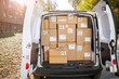 © pikselstock - Courier van full of parcels and boxes