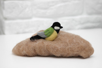 Wool felted bird on wool for felting