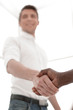 © ASDF - close up. young businessman shaking hands with business partner