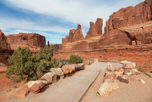 Pathway To A Viewpoint Overlooking The Beautiful Red Rock Canyon Landscape During A Vibrant Sunny Day. Taken In Arches National Park, Located Near Moab, Utah, United States.