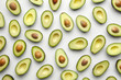 © 365mm/Stocksy - Avocado wallpaper on white background.
