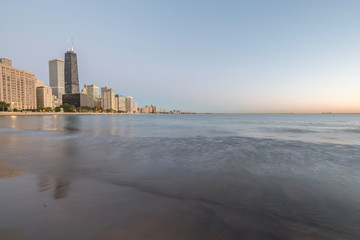 Wall Mural - Chicago skylines along Lake Shore Drive reflection from beach park at sunrise