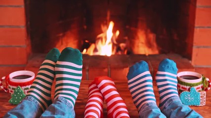 Poster - Family in Christmas socks near fireplace