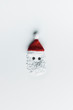 © Beatrix Boros/Stocksy - Minimalist Santa Claus face on white