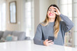 © Krakenimages.com - Young beautiful woman using smartphone at home with happy face smiling doing ok sign with hand on eye looking through fingers