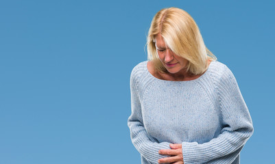 Canvas Print - Middle age blonde woman wearing winter sweater over isolated background with hand on stomach because indigestion, painful illness feeling unwell. Ache concept.