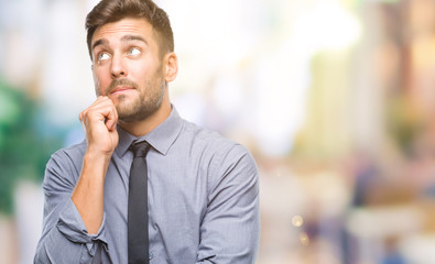 Sticker - Young handsome business man over isolated background with hand on chin thinking about question, pensive expression. Smiling with thoughtful face. Doubt concept.