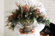 © Nabi Tang/Stocksy - Woman hand holding beautiful vintage frosty Christmas decoration
