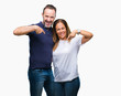 © Krakenimages.com - Middle age hispanic casual couple over isolated background looking confident with smile on face, pointing oneself with fingers proud and happy.