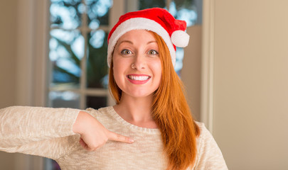 Sticker - Redhead woman wearing santa claus hat with surprise face pointing finger to himself