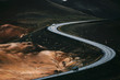 © VISUALSPECTRUM/Stocksy - Two Cars Driving S Curve in Black Volcanic Landscape (Iceland)