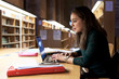 © Guille Faingold/Stocksy - Student using laptop while doing homework