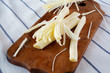 © Liudmyla - String cheese on rustic wooden board on striped napkin, side view. Healthy snack. Closeup.