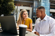 © Jacob Lund - Business colleagues talking while sitting at office cafeteria
