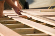 Man placing a plank of wood in a deck home renovation