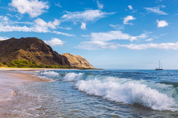 Wall Mural - Makua beach view of the wave with beatiful mountains and a sailboat in the background, Oahu island, Hawaii