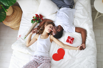 Wall Mural - Valentine's Day. happy couple  with flowers in bed.