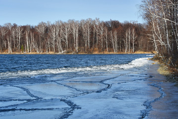 Cracks in the blue ice of lake Uvildy near the shore of the islandVyazovy. South Ural, Chelyabinsk region, Russia