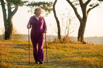 senior woman hiking in forest or park