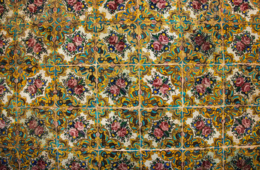 Colorful mosaic and ceramic tiles in the traditional Persian style on the wall of the old Golestan Palace