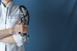 Doctor in white coat with a stethoscope standing with arms folded, closeup