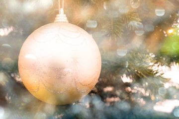 christmas balls hanging on the christmas tree. close-up. blurred focus. bright glare from lighting.