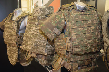 Army camouflaged body armor in the store. Weapons