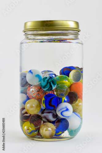 Cuadros en Lienzo Jar of vibrant colored marbles.