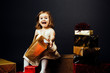 © Carlos David - Smiling girl opening gift