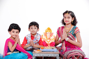 Little Indian children with lord ganesha and praying , Indian ganesh festival