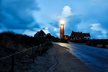 Fototapete - road to red lighthouse in night