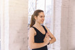 © Ivan - Close-up cheerfull young girl doing yoga alone in the yoga studio near the window in the morning. Standing in a pose of greeting on the floor indoor