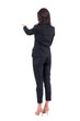 © sharplaninac - Rear back view of business woman in suit interacting with touch screen or pointing finger at presentation. Full body isolated on white background.